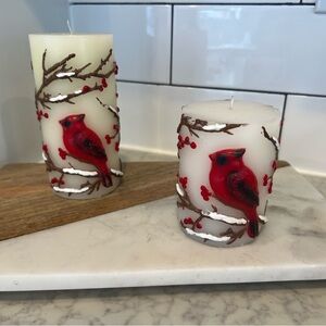 Set of 2 candles with red cardinal bird on branch with berries.